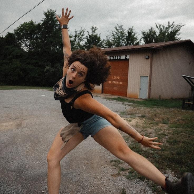 Avery Kim, Lead Design Curator at MarbleTrailPaper, reviewing corporate floral arrangements